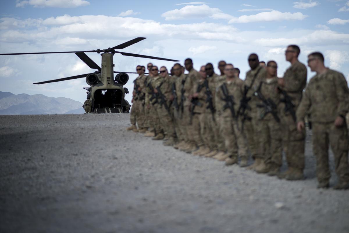  U.S. soldiers lining up as they wait to bid farewell to wounded veterans during "Operation Proper Exit" at Forward Operating Base Shank in Afghanistan's Logar Province on on May 28, 2014. (Brendan Smialowski/AFP/Getty Images)