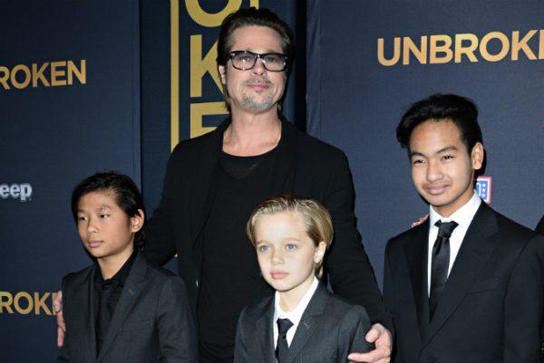 Actor Brad Pitt and children Pax Jolie-Pitt (L), Shiloh Jolie-Pitt (C) and Maddox Jolie-Pitt arrive for the U.S. premiere of Universal Pictures 'Unbroken' at the Dolby Theatre in Hollywood, California, on Dec. 15, 2014. (Robyn Beck/AFP/Getty Images)