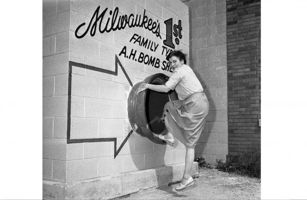 A woman shows how to enter a family bomb shelter in Milwaukee in 1958. (AP Photo)