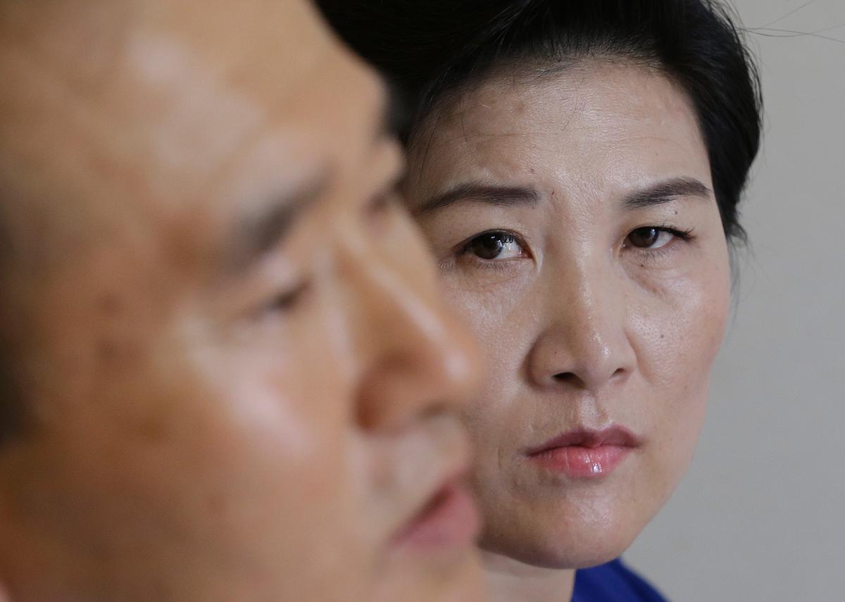  North Korean defector Kim Jungah (R) watches her husband Kim Jong Phil speak during an interview at their house in Gunpo, South Korea, on Sept. 4, 2016. (AP Photo/Ahn Young-joon)