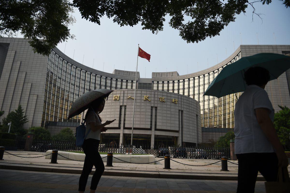 Pedestrians walk past the People's Bank of China on July 8, 2015. (Greg Baker/AFP/Getty Images)