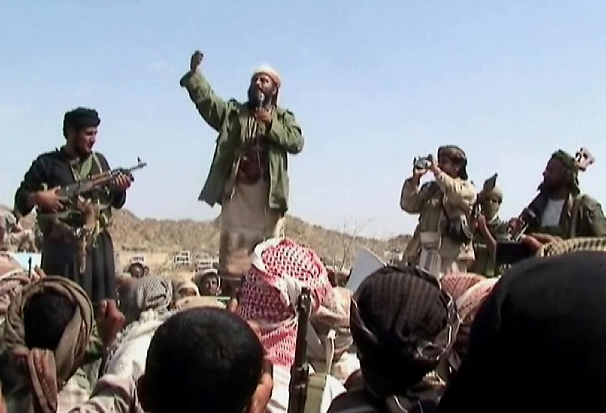 A man claiming to be an al-Qaida member addresses a crowd gathered in southern Yemen's Abyan Province on Dec. 22, 2009. (AFP/Getty Images)