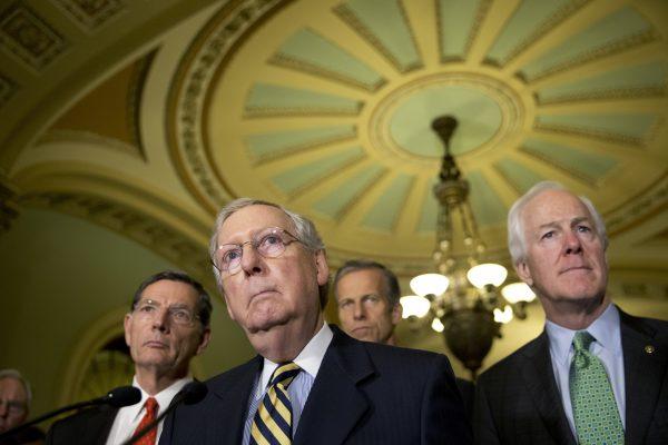 Senate Majority Leader Mitch McConnell of Ky., accompanied by (L-R) Sen. John Barrasso, R-Wyo., Sen. John Thune, R-S.D., and Senate Majority Whip John Cornyn of Texas, listen to a question during a news conference on Capitol Hill in Washington, in this file photo. (AP Photo/Alex Brandon)