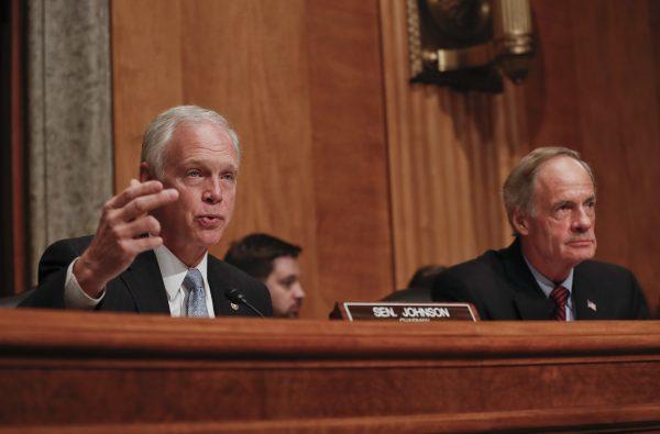 Senate Homeland Security and Governmental Affairs Committee Chairman Sen. Ron Johnson, R-Wis. (L) accompanied by the committee's ranking member Sen. Tom Carper, D-Del., at Capitol Hill in Washington on Sept. 27, 2016. (AP Photo/Pablo Martinez Monsivais)