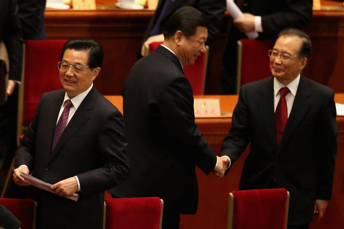 Former Chinese premier Wen Jiabao (C) walks past former Chinese leader Hu Jintao (L) and the current leader Xi Jinping (R) at the closing session of the rubber-stamp legislature’s congress in Beijing, China on March 17, 2013. (Feng Li/Getty Images)