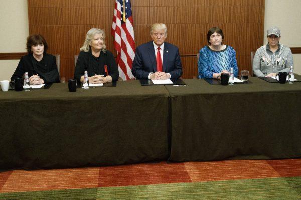 Then-Republican presidential candidate Donald Trump (C) sits with (L-R) Paula Jones, Kathy Shelton, Juanita Broaddrick, and Kathleen Willey at Washington University in St. Louis on Oct. 9, 2016. (Evan Vucci/AP Photo)