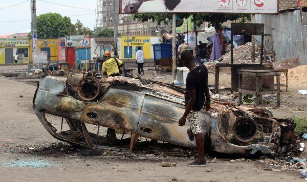 A burnt-out car after a protest in Kinshasa, Democratic Republic of Congo, on Sept. 19, 2016. (John Bompengo/AP Photo)