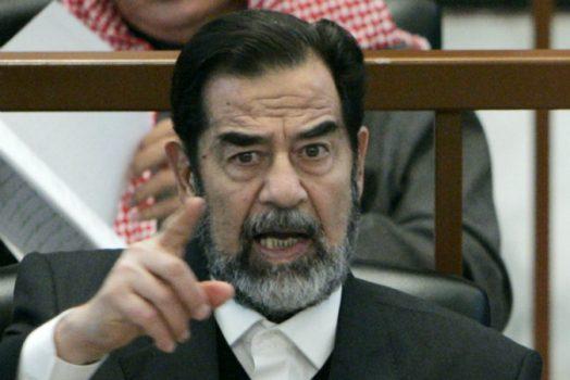 Former Iraqi President Saddam Hussein points while listening to the prosecution during his 'Anfal' genocide trial in Baghdad, Iraq, on Dec. 21, 2006.  (Nikola Solic-Pool/Getty Images)
