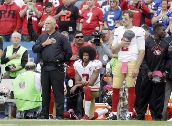 San Francisco 49ers quarterback Colin Kaepernick (7) kneels during the national anthem before an NFL football game against the Buffalo Bills in Orchard Park, N.Y., on Oct. 16, 2016. (AP Photo/Mike Groll)