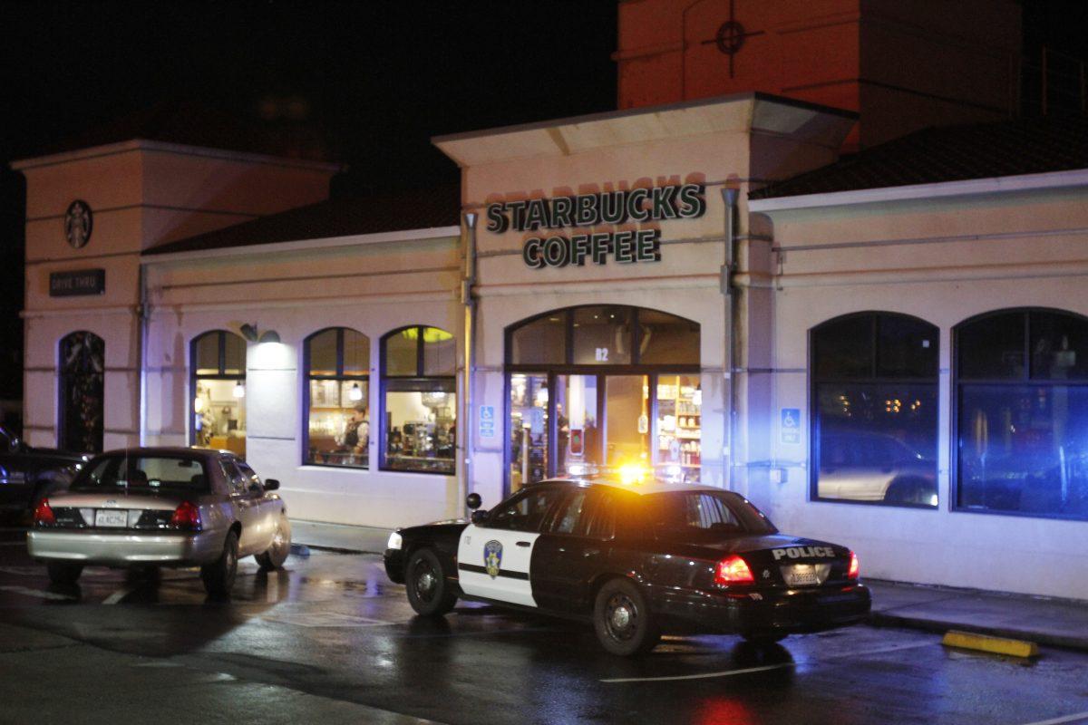 Vallejo Police officers work at the scene of a shooting in Vallejo, Calif., on Sunday, Oct. 16, 2016. Two Northern California police officers who were taking a break at a coffee shop were targeted in an ambush that was foiled when the shooter's gun malfunctioned, a police chief said. (Chris Preovolos/San Francisco Chronicle via AP)
