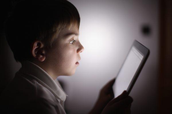 Child interacting with tablet technology. (Christopher Furlong/Getty Images)