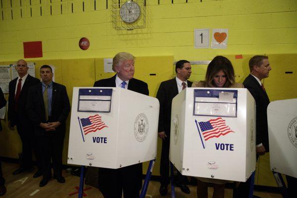Republican presidential candidate Donald Trump looks at his wife Melania as they cast their votes at PS-59 on Nov. 8, 2016, in New York. (AP Photo/ Evan Vucci)