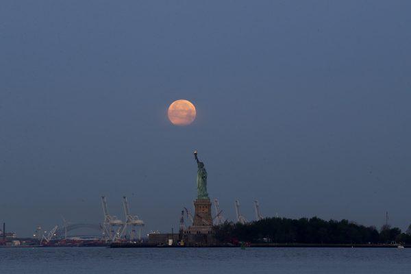 A supermoon over the Statue of Liberty in New York. (Julio Cortez/AP Photo)