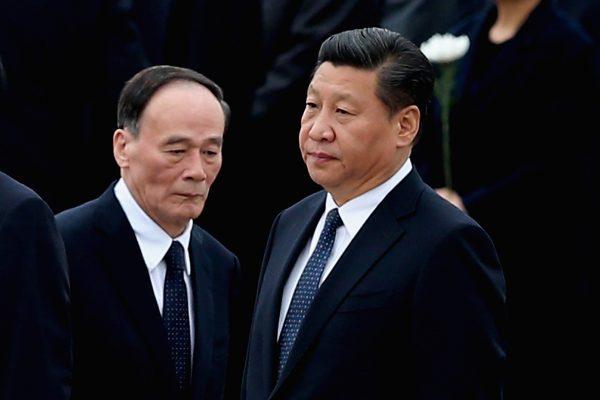 Chinese leader Xi Jinping (R) and former anti-corruption chief Wang Qishan in Beijing on Sept. 30, 2014. (Feng Li/Getty Images)