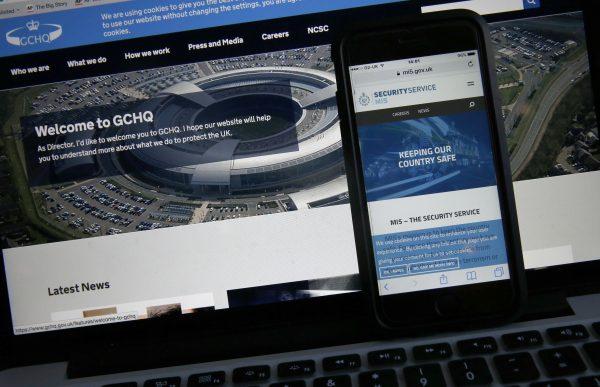 Photo-illustration of web flash pages for GCHQ, the British government's communications and electronic surveillance headquarters, and The Security Service (MI5) on a computer and smartphone in London, on Nov. 25, 2016. (Alastair Grant/AP Photo)