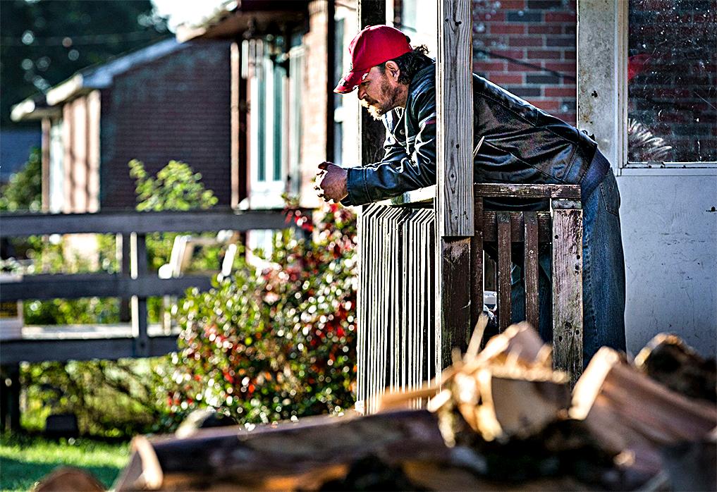 In this photo made Danny Newell, an unemployed former logger, hangs out at his home Wednesday, Oct. 2, 2013, in Indian Township, Maine. (AP Photo/Robert F. Bukaty)