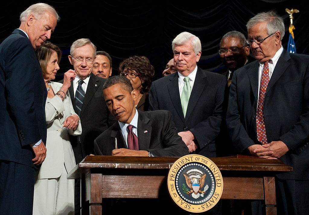 Then-President Barack Obama is seen signing the Dodd-Frank Wall Street Reform and Consumer Protection Act alongside members of Congress in a file photo. It established the CFPB in 2011. (Saul Loeb/AFP/Getty Images)
