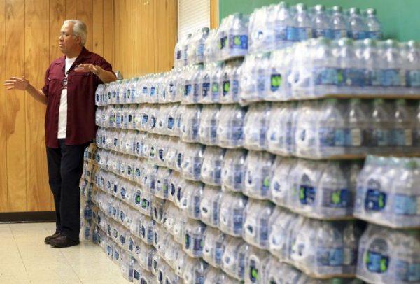 Superintendent Dr. Arturo Almendarez from Calallen Independent School District, speaks about how his district has bottles of water for students in December 2016, in Corpus Christi, Texas, after the city's water system was contaminated with petroleum-based chemicals. (Gabe Hernandez/Corpus Christi Caller-Times via AP)
