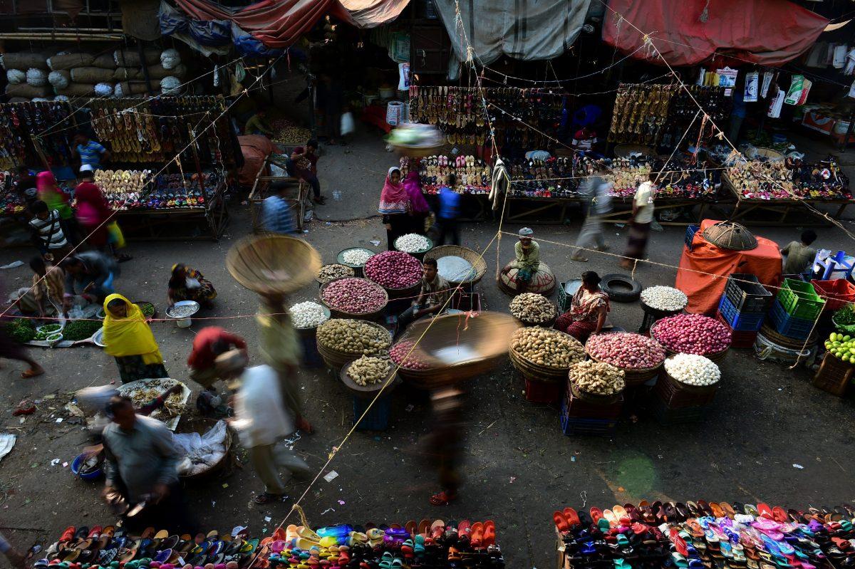 Bangladeshi vendors wait for customers at a wholesale market in Dhaka on Jan. 22, 2017. Dhaka Kawran Bazar is a major business district and wholesale marketplace in Dhaka. (STR/AFP/Getty Images)