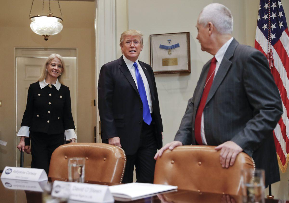 Then-President Donald Trump, followed by then-Counselor to the President Kellyanne Conway, left, walks into the Roosevelt Room of the White House in Washington, Wednesday, Feb. 1, 2017. (AP Photo/Pablo Martinez Monsivais)