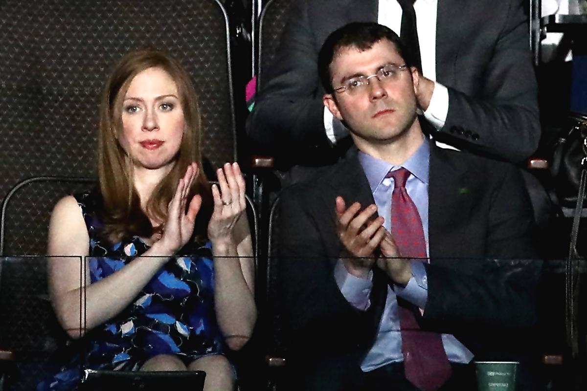 Chelsea Clinton and along with her husband Marc Mezvinsky clap as they listen to speakers on the second day of the Democratic National Convention at the Wells Fargo Center in Philadelphia, Pennsylvania on July 26, 2016. (Win McNamee/Getty Images)