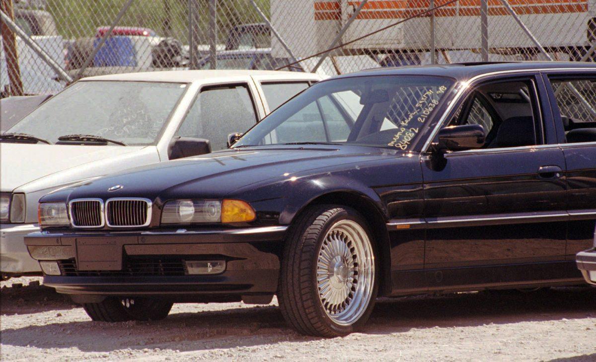 A black BMW, riddled with bullet holes, in a Las Vegas police impound lot on Sept. 8, 1996. The car, which was driven by Marion "Suge" Knight, was carrying Tupac Shakur when he was fatally gunned down. (AP Photo/Lennox McLendon, File)