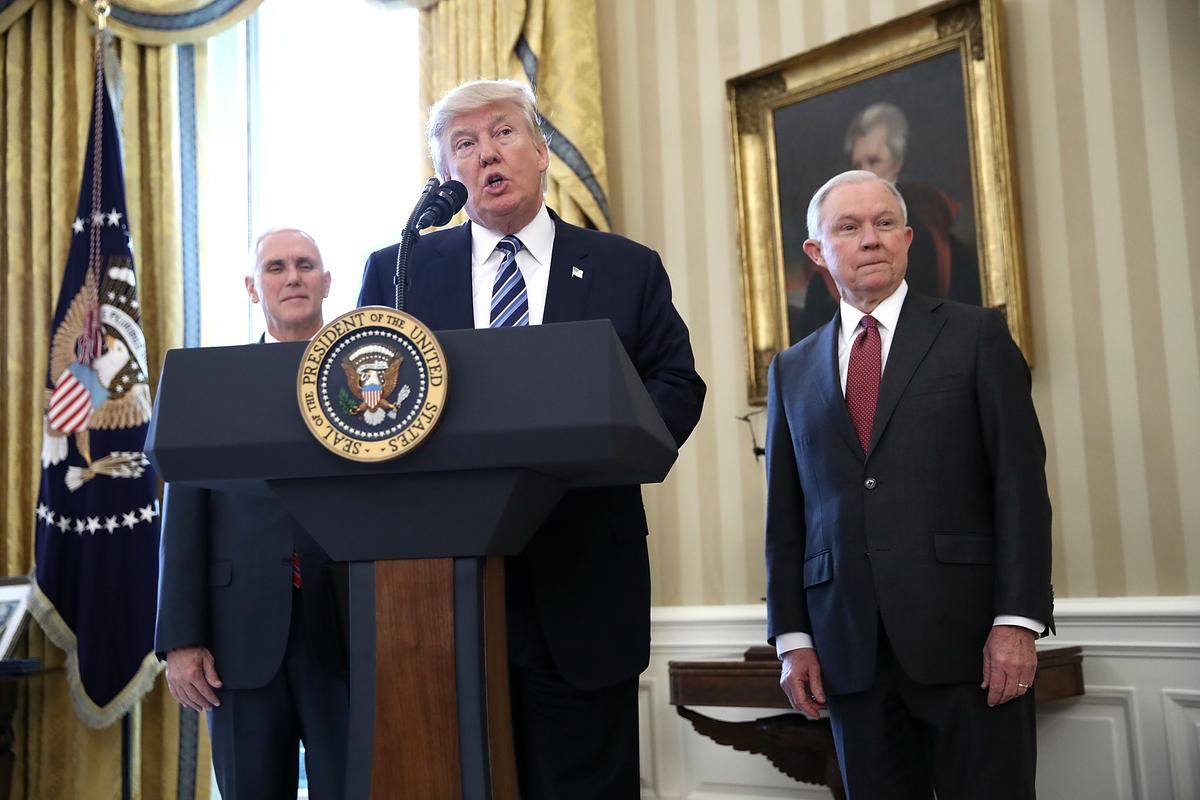 President Donald Trump (C) delivers remarks before the swearing-in ceremony for Sen. Jeff Sessions (R) in the Oval Office of the White House in Washington on Feb. 9, 2017. (Win McNamee/Getty Images)