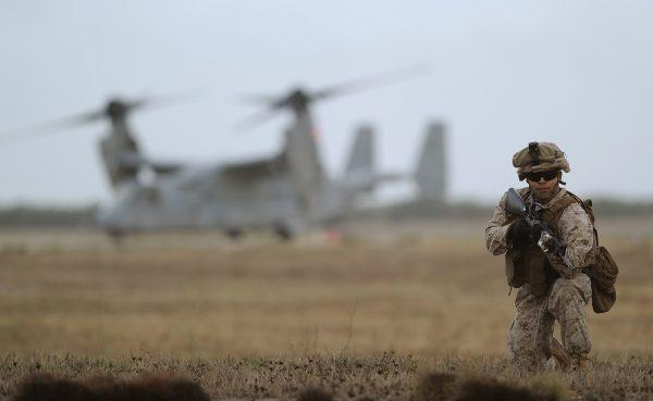 A V-22 Osprey and a Marine perform a demonstration at the U.S. Marines base in Moron de la Frontera on Oct. 6, 2015. (Cristina Quicler/AFP/Getty Images)