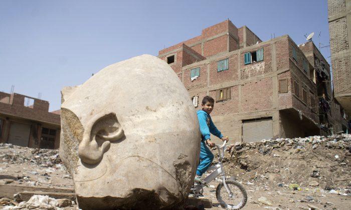 Egypt Archaeologists Discover Massive Statue in Cairo Slum