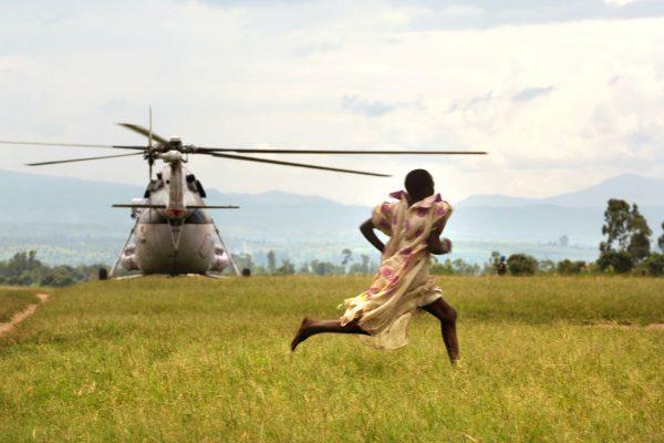 A girl runs as a U.N. helicopter lands at a refugee camp in Kiwanja, Democratic Republic of Congo, on Nov. 7, 2008. (Uriel Sinai/Getty Images)