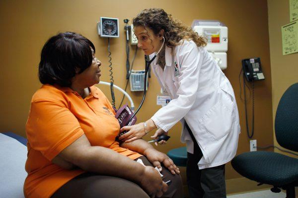 A woman is examined by a doctor during a routine checkup at the Jessie Trice Center for Community Health clinic in Miami in 2012. (Joe Raedle/Getty Images)