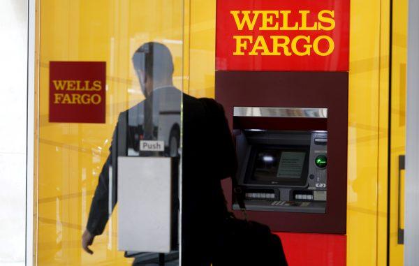 A man walks by a bank machine at the Wells Fargo & Co. bank in downtown Denver, Colo., on April 13, 2016. (Rick Wilking via Reuters)