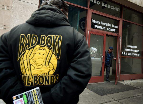 A man in a Bad Boys Bail Bonds jacket waits outside the Sheriff's Department Inmate Reception Center in Los Angeles on Jan. 30, 2015. (Mark Ralston/AFP/Getty Images)