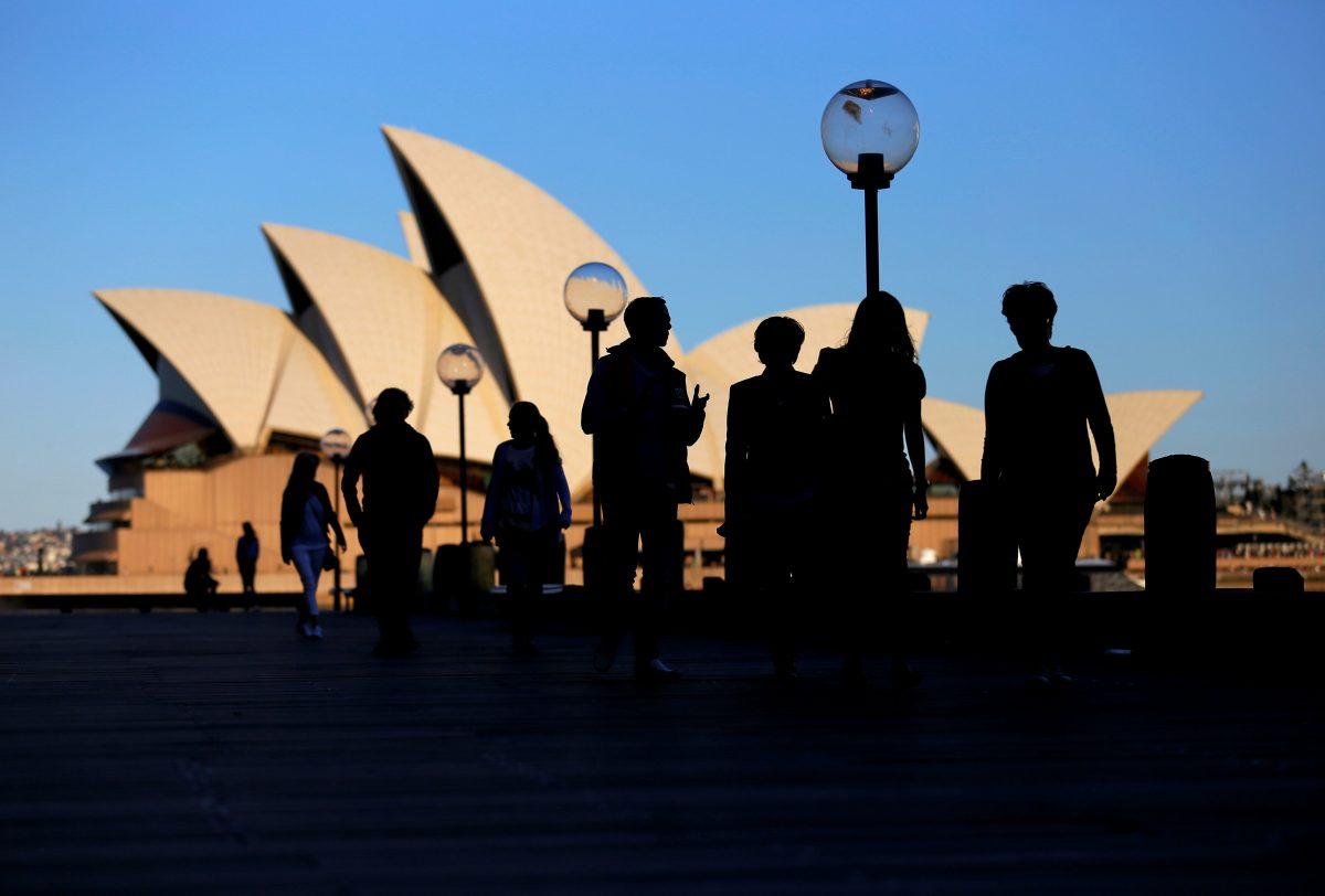 People walk in front of the Sydney Opera House, Australia, on Nov. 2, 2016. (Steven Saphore/Reuters)
