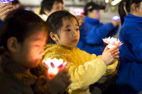 Young Falun Gong practitioners attend a candlelight vigil near the Chinese Consulate in New York on April 23, 2017. (Samira Bouaou/The Epoch Times)