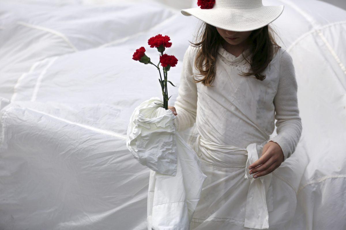 A girl carries red carnations while participating in a parade celebrating the April 25, 1974, revolution, also known as the Revolution of the Carnations, in Lisbon, Portugal, on April 25, 2017. The red carnation symbolizes the 1974 revolution that restored democracy to Portugal after nearly half a century of fascist dictatorship. (Armando Franca/AP Photo)