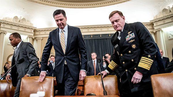 Former FBI Director  James Comey (L) and then-National Security Agency Director Michael Rogers prepare for a 2019 Congressional hearing on a FISA report detailing how communications of Americans were unlawfully monitored by U.S. spy agencies, and that some of the communications were passed to contractors by the FBI. (Drew Angerer/GETTY IMAGES)