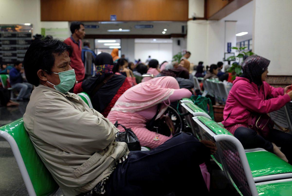 Patients and families wait for their turn to register at Dharmais Hospital, Indonesia's biggest cancer hospital, after the institution suffered cyberattacks affecting scores of computers in Jakarta, on May 15, 2017. (Darren Whiteside/Reuters)