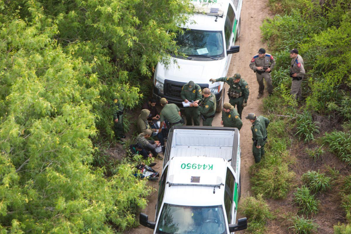 A view from a Border Patrol helicopter, shows the Texas Border Patrol and Texas State Troopers detaining illegal aliens who were trying to remain hidden after they came over to the United States from Mexico in the Texas area of near McAllen, Texas, on May 30, 2017. (Benjamin Chasteen/The Epoch Times)