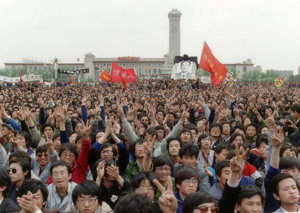 Students gesture and shout slogans as they pay respect to former Chinese Communist Party leader Hu Yaobang near the monument to the People's Heroes in Tiananmen Square during an unauthorized demonstration to mourn the death of Hu Yaobang, on 22 April 1989. (Catherine Henriette/AFP/Getty Images)