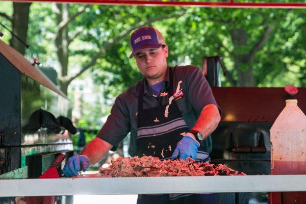 Chopping pulled pork at the Big Bob Gibson BBQ stand. (Benjamin Chasteen/The Epoch Times)