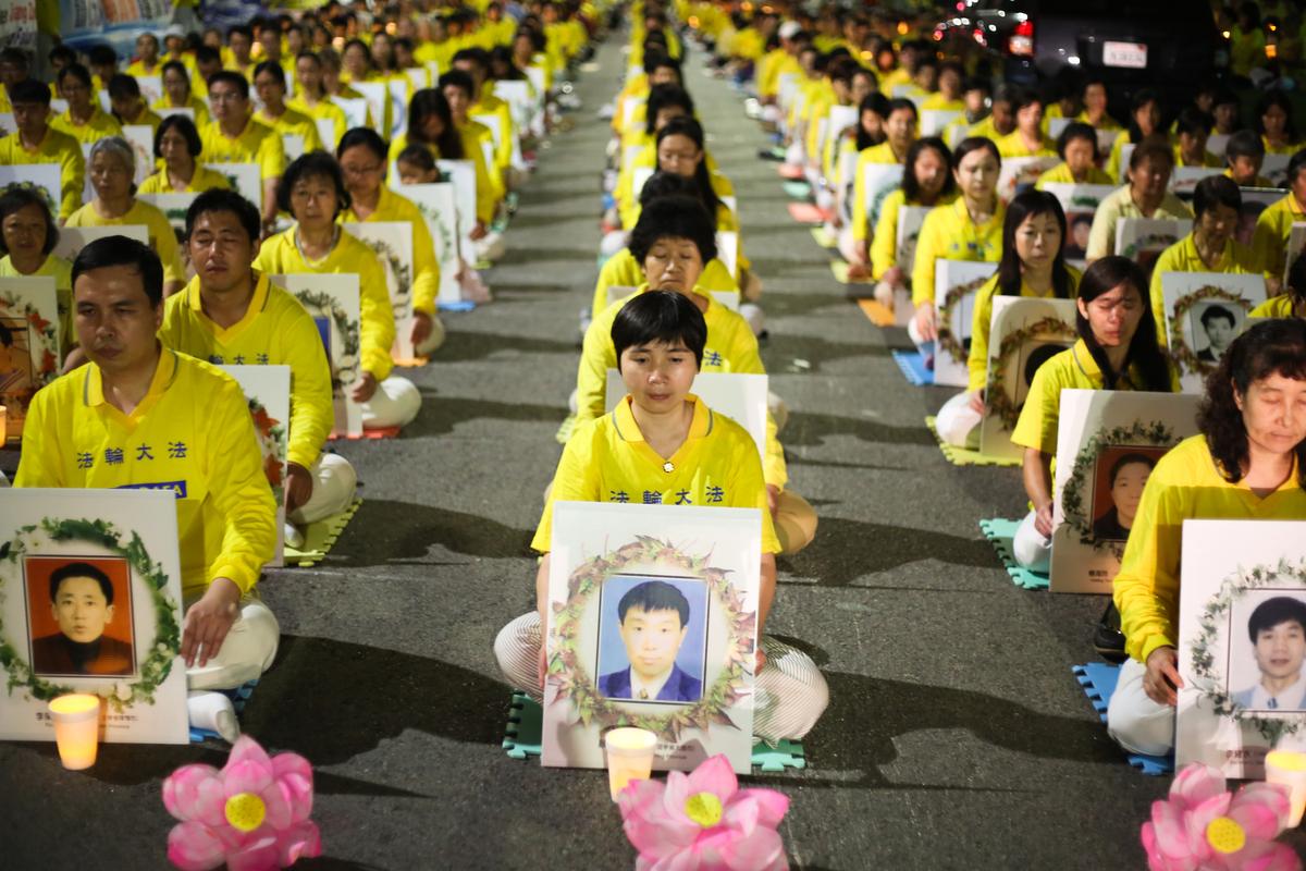 Falun Gong practitioners hold a candlelight vigil in front of the Chinese Consulate in Los Angeles on Oct. 15, 2015, for those who have died during the 16 year persecution in China. They demand that Jiang Zemin be brought to justice. (Benjamin Chasteen/The Epoch Times)