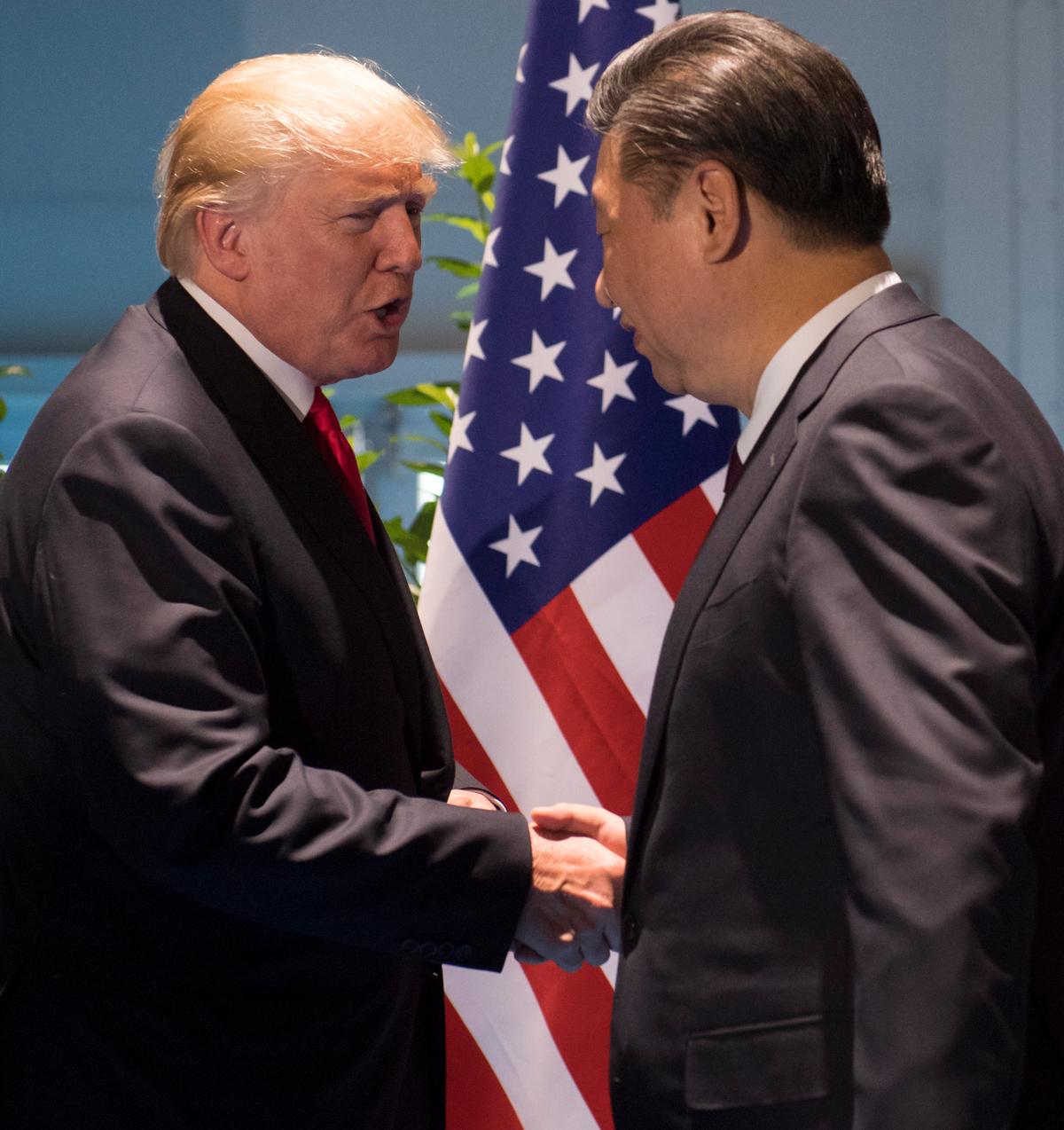 President Donald Trump and Chinese leader Xi Jinping (R) shake hands prior to a meeting on the sidelines of the G20 Summit in Hamburg, Germany, on July 8, 2017. (Saul Loeb/AFP/Getty Images)