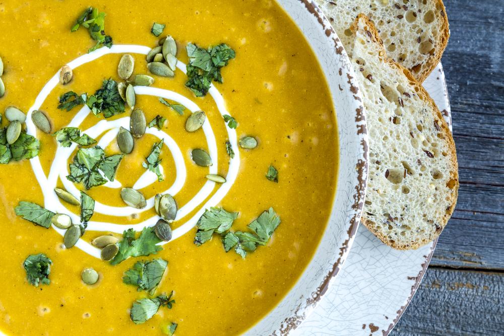 Pumpkin squash soup garnished with cream, cilantro and pumpkin seeds. Here cilantro will enliven the spleen and stimulate the appetite. (Teri Virbickis/Shutterstock)