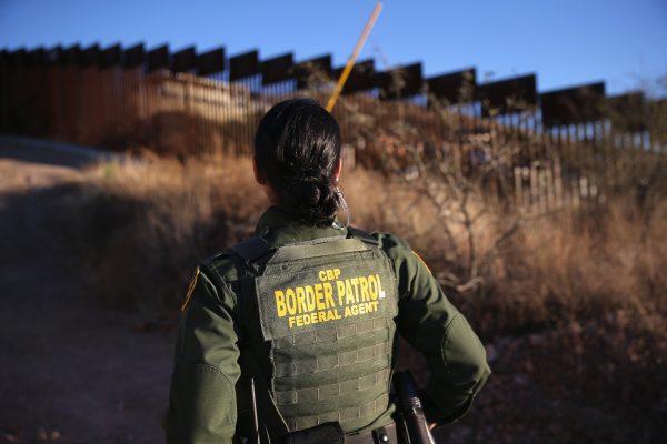 U.S. Border Patrol agent Nicole Ballistrea watches over the U.S.-Mexico border fence in Nogales, Arizona on December 9, 2014. (John Moore/Getty Images)