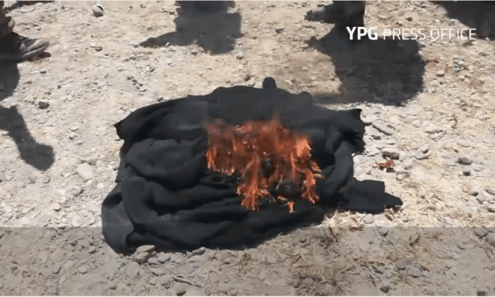 Women Burn Burqas, Men Shave Beards After Escaping ISIS in Syria