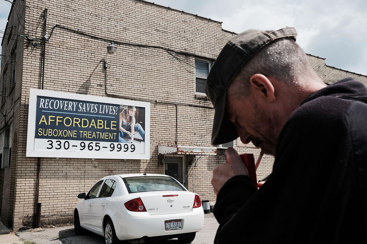 A man walks by a billboard for a drug recovery center in Youngstown, Ohio on July 14, 2017. (Spencer Platt/Getty Images)