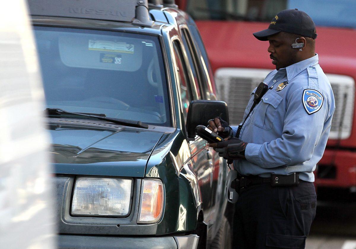 A San Francisco Department of Parking and Traffic officer issues a parking ticket for an illegally parked car in San Francisco on Jan. 21, 2011. (Justin Sullivan/Getty Images)