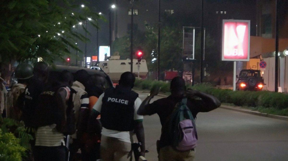 Police are seen on a street following an attack by gunmen on a restaurant in Ouagadougou, Burkina Faso, in this still frame taken from video on Aug. 13, 2017. (Reuters TV)