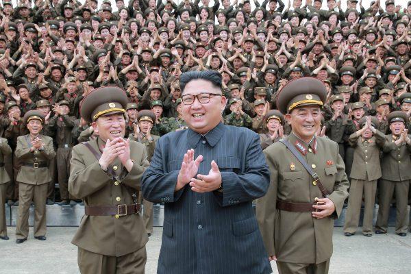 North Korean leader Kim Jong Un with military officers at the Command of the Strategic Force of the Korean People's Army (KPA) in an unknown location in North Korea on Aug. 15, 2017. (KCNA/via Reuters)